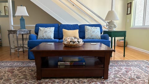 Comfy couch and stairs leading to master suite.