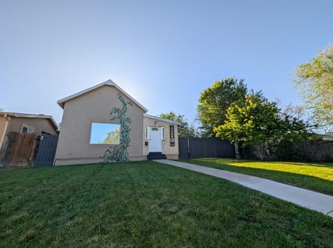 Welcome to the Denver Oasis — signature green mural & sunny front lawn