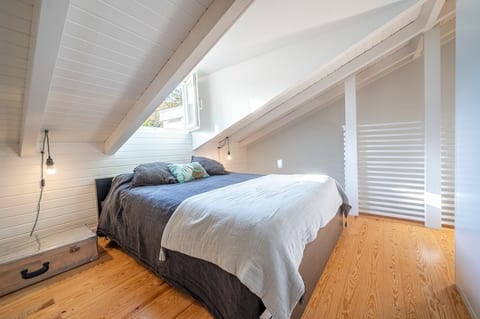 Attic Retreat: Bright and airy with textured wooden details, perfect for a rejuvenating escape!