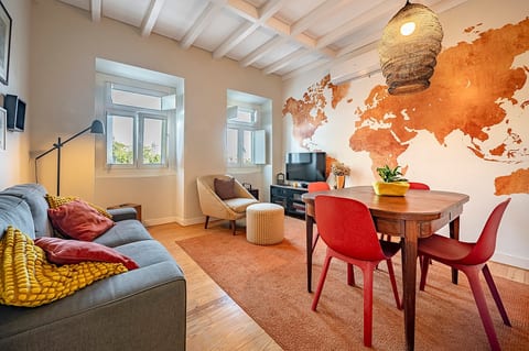 Living Room: Bright and vibrant space featuring a world map mural, perfect for relaxation and fun!