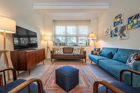Living Room: Bright and inviting space with stylish seating, vibrant art, and natural light.