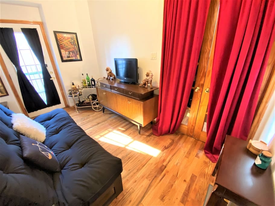 This sun-drenched, spacious private bedroom has wood-flooring throughout.