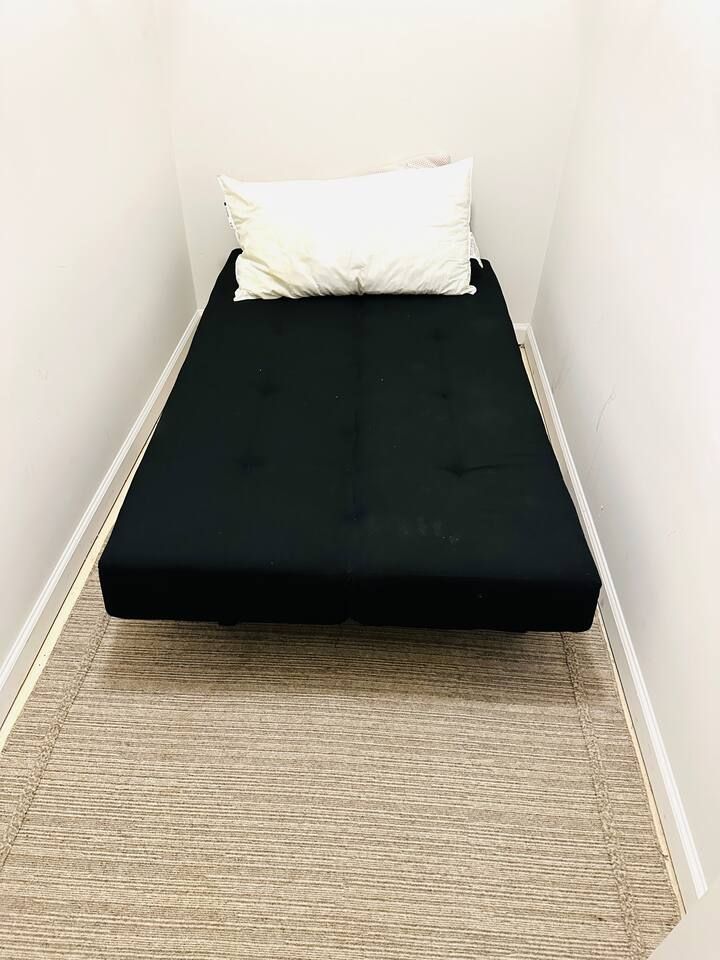 upstairs and downstairs master bedroom closet have a full size futon bed 