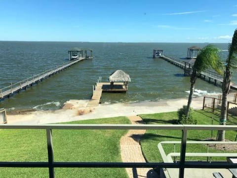 The view from upstairs balcony. The home’s 50 ft pier with palapa which features swim ladder, lighting, fishing light and electric outlets.