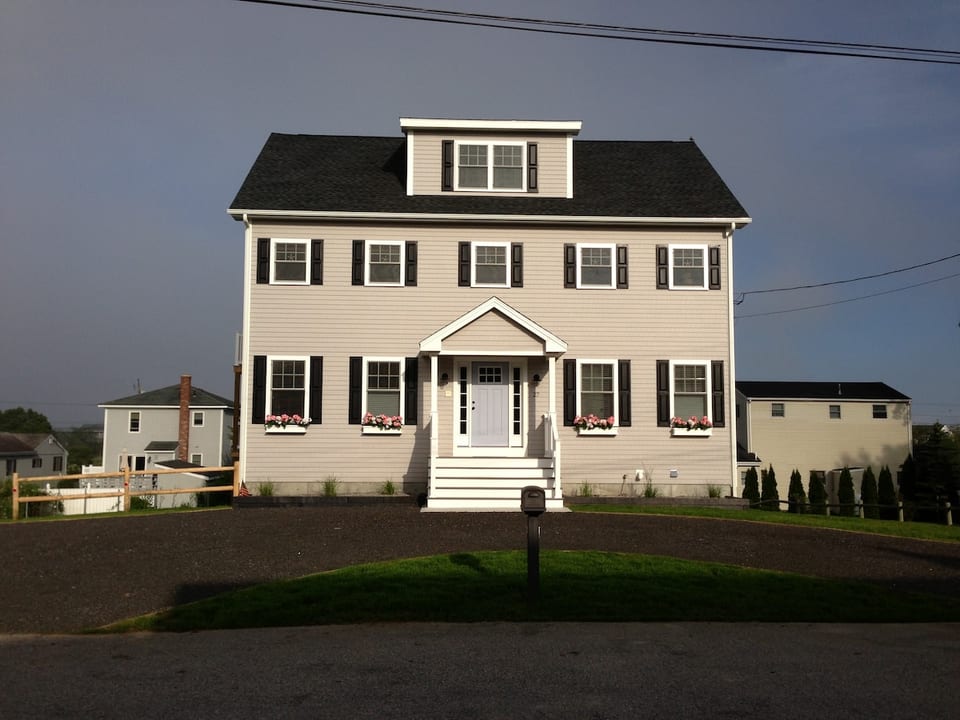 The front of the house with expansive private parking onsite.