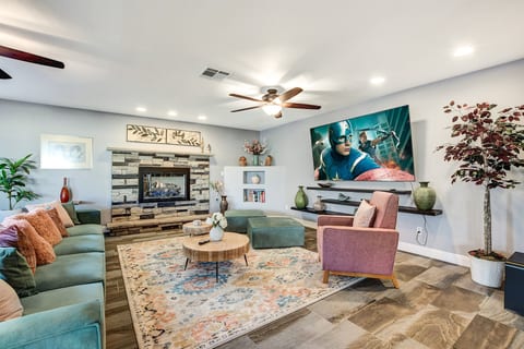 Fashionable and comfortable living room with fireplace and 85" SmartTV