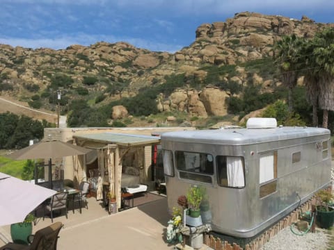 The view from the nearby rocks! The patio is super comfortable. New curtains on the Tiki Bed and Gazebo for more privacy or if there are 4 guests.