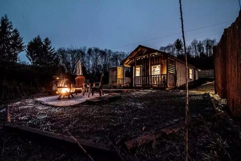 Outside at night with a fire in the fire pit