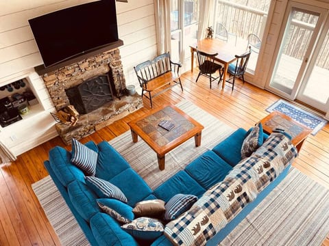 Living room (main level) - section sofa with pull-out queen bed, coffee nook, wood-burning fireplace (wood provided at no charge), puzzle/game table