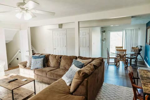 One of two living spaces in the home. This one boasts a 65" Smart TV with Bluetooth Soundbar, desk/work area, and small dining nook for dining overflow seating for larger groups.
