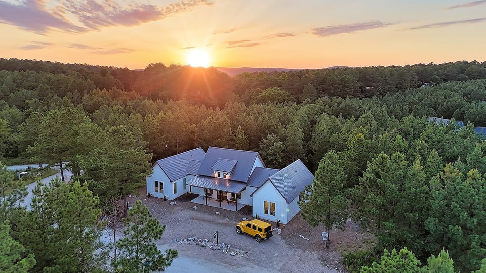 Gorgeous aerial view of Morning Glory and the beautiful pine trees surrounding our property. The road in front of our property has been blacktopped, providing easy access in and out.