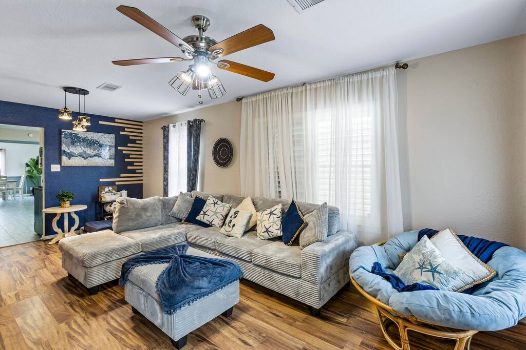 The living room has plenty of seating for the family to gather around the TV or play a fun game together. We also have a doggy corner with snacks and bowls for their food and water.