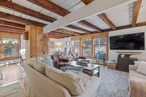 Living room with game table, reading nook, and large screen television