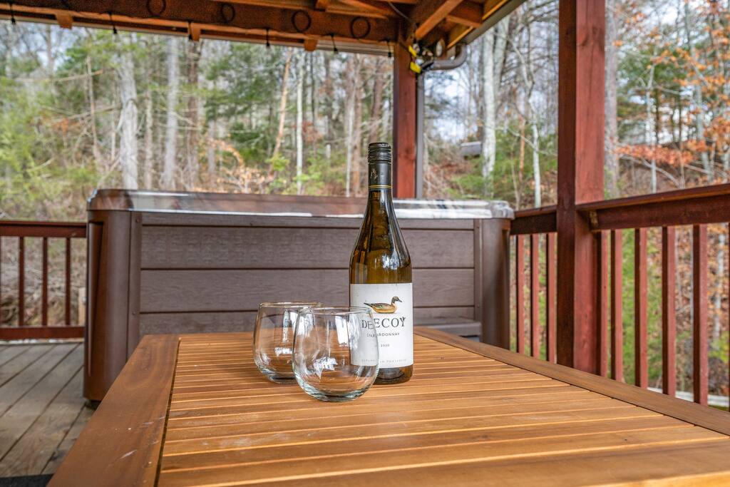 It's a perfect day to unwind and enjoy a glass of your favorite wine by the hot tub, with the soothing sound of a nearby creek in the background.