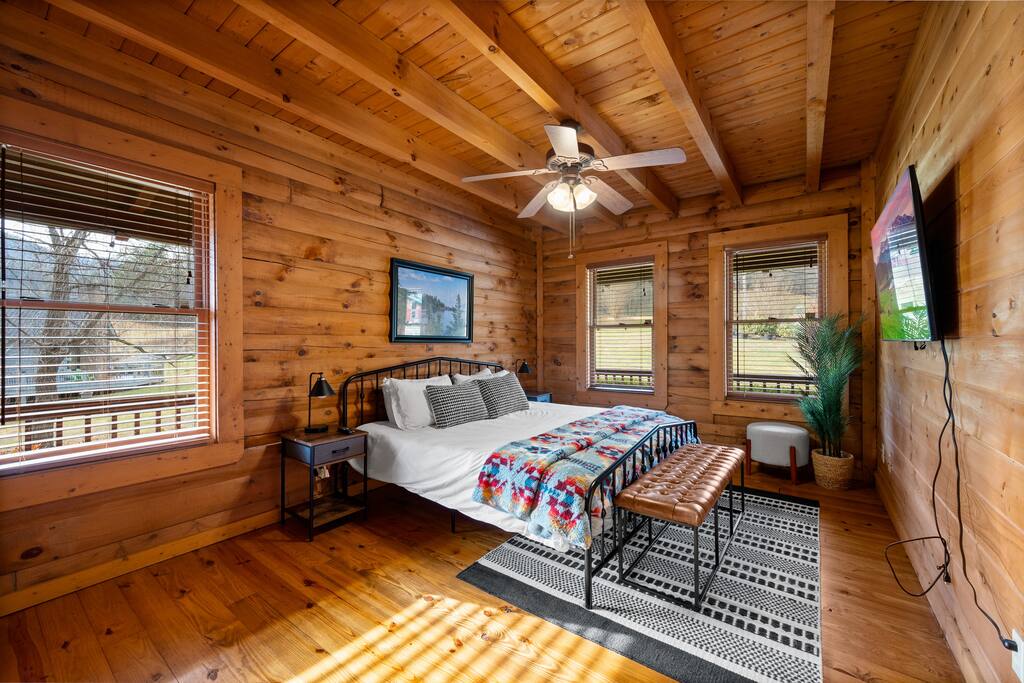 Plenty of natural lights with the beauty of the mountains surrounding the cabin.  Modern and stylized King size bed.