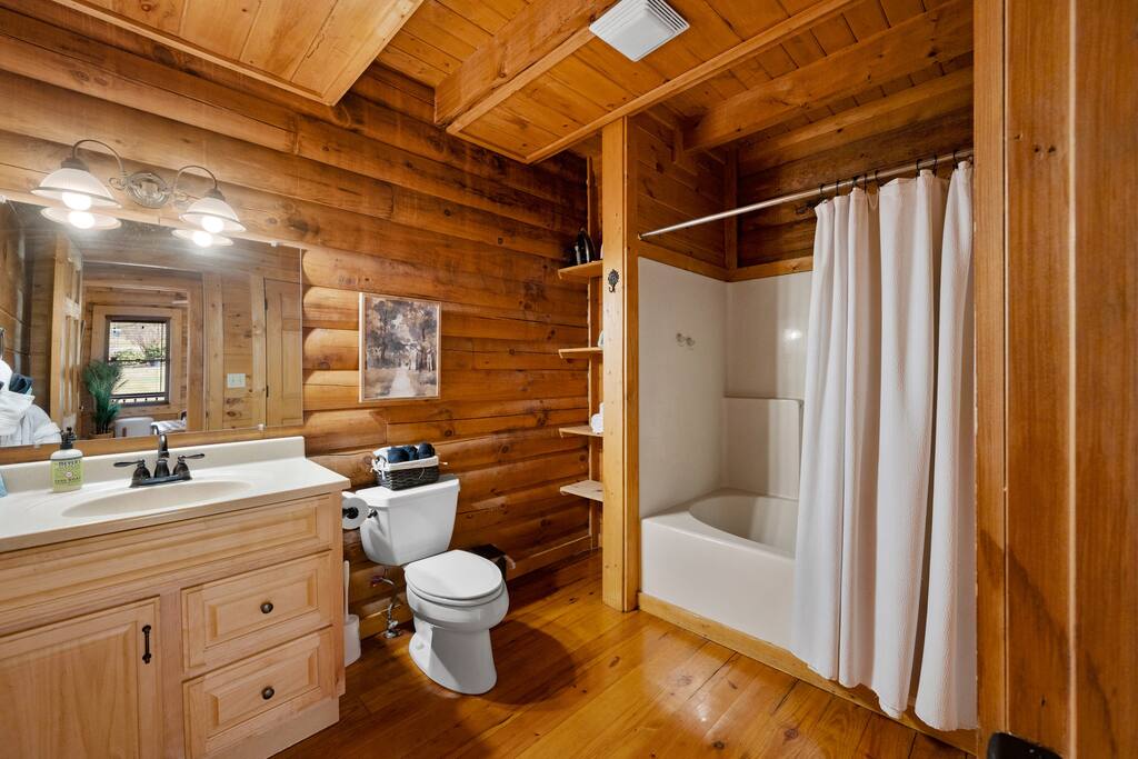 Spacious bathroom on the ground floor. Minimalist decor yet cozy feeling.   Shower and tub.