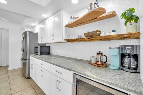 The kitchen includes a backsplash made of real shells, floating driftwood shelves made by a local artist, granite countertops, and all the appliances and accessories you will need.