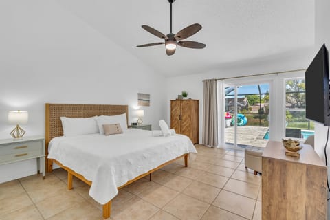 The primary bedroom has a king bed, armoire and dresser for clothing storage, and direct access to the swimming pool.