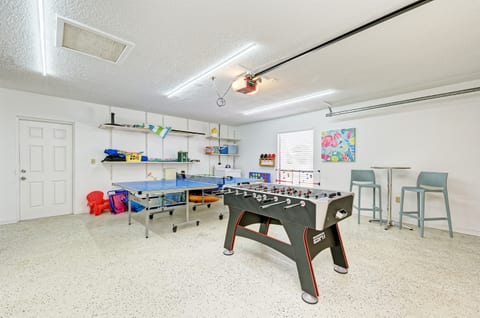 The garage of the home has foosball, darts, and a pingpong table. There are beach chairs, toys, and umbrellas available for guests to use.