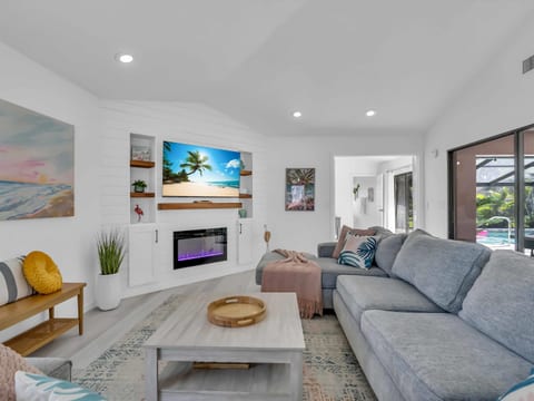 Enjoy a movie night after a day at the beach! The living room has a large cozy sectional, tv, and fireplace.