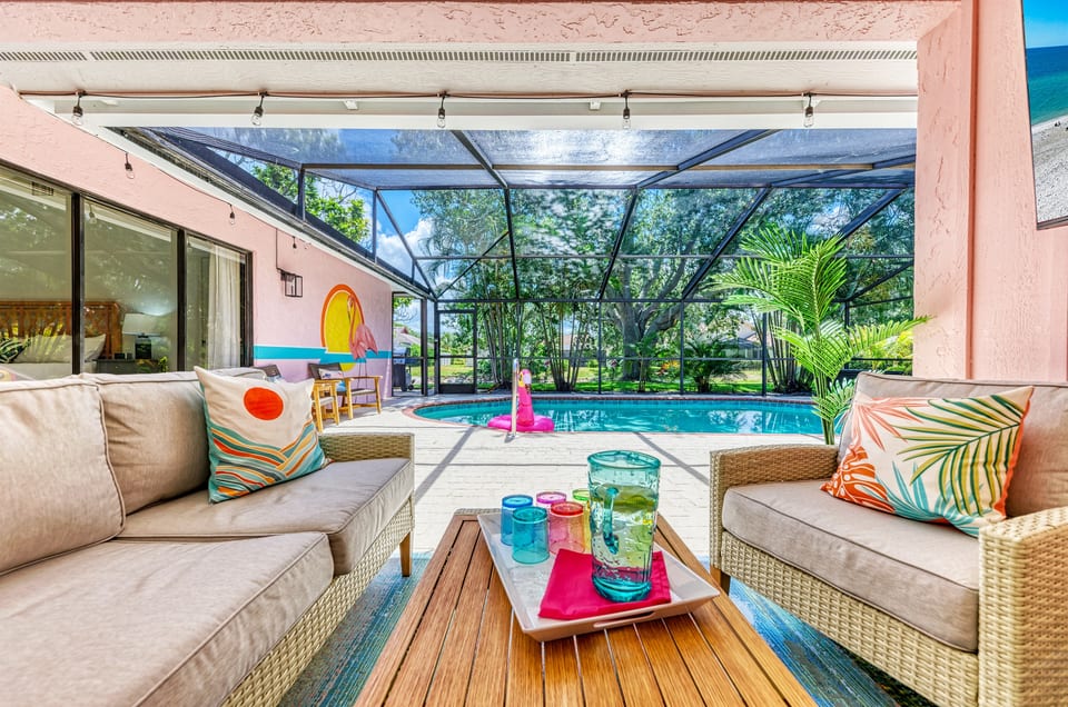 Guests love the outdoor space of this home, which includes a heated pool, covered seating area with a Roku TV, outdoor dining space and mural. Everything is screened so bugs and tropical wildl