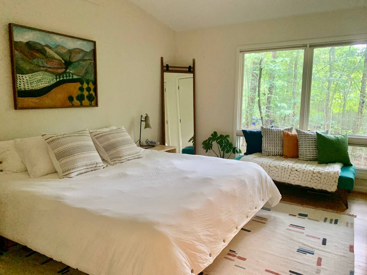 Handwoven rug by Lulu & Georgia. Peaking at you from the mirror: Two expansive closets to store your luggage — or your entire wardrobe.  - Mid-Century Designer w/ King Beds & Sonos Stereo - Chapel Hill