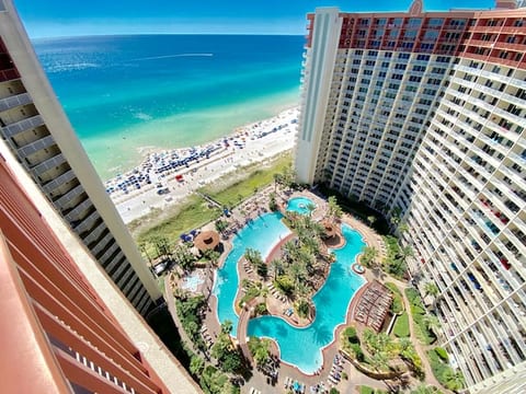 View of epic pool, tiki bar & grill, hot tub, and gulf from balcony