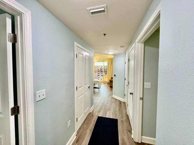 Hallway after entering unit. Bunk room on left, rear king bedroom on the right