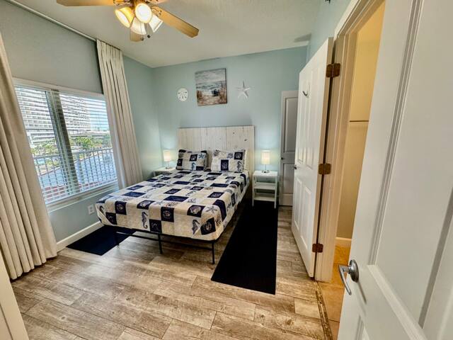 Queen bedroom has private full bath and custom blackout drapes with blind