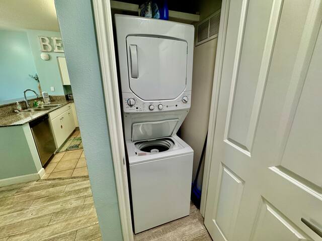 Washer and dryer in hall next to kitchen