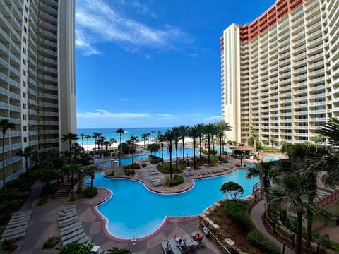 View of epic pool, tiki bar & grill, hot tub, and gulf from balcony