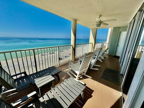 Sliding glass door behind rocking chairs and private access from front bedroom behind adirondack chairs