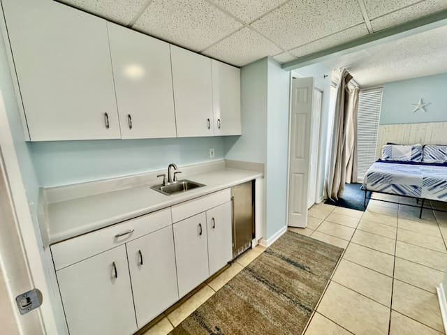 Kitchenette with ice maker located in entry of rear queen bedroom
