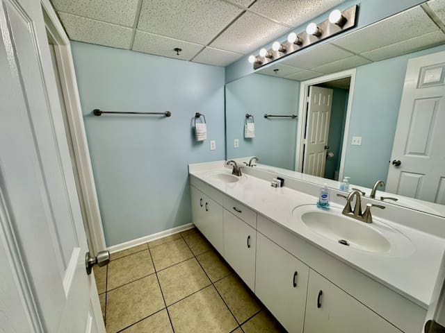 Double sinks and toilet shower / tub room for rear bedroom private full bath