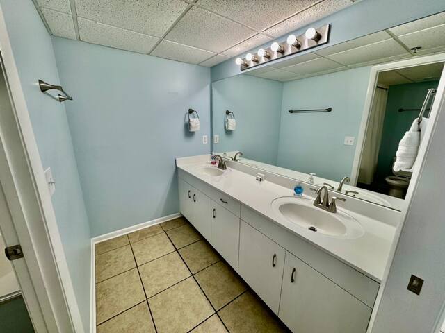 King bedroom private full bath with shower / tub combo and double sinks