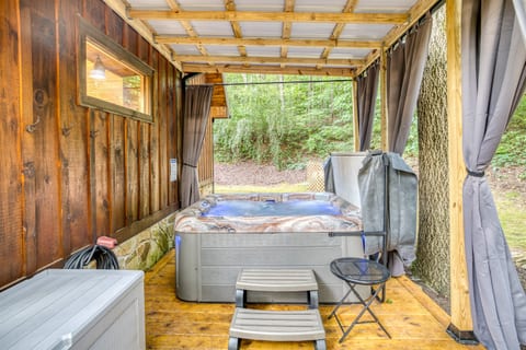 This hot tub is the perfect spot for a private evening soak. It's secluded under a new roof, and surrounded with curtains for privacy. The bubbling water creates a tranquil atmosphere, perfect for relaxing.
