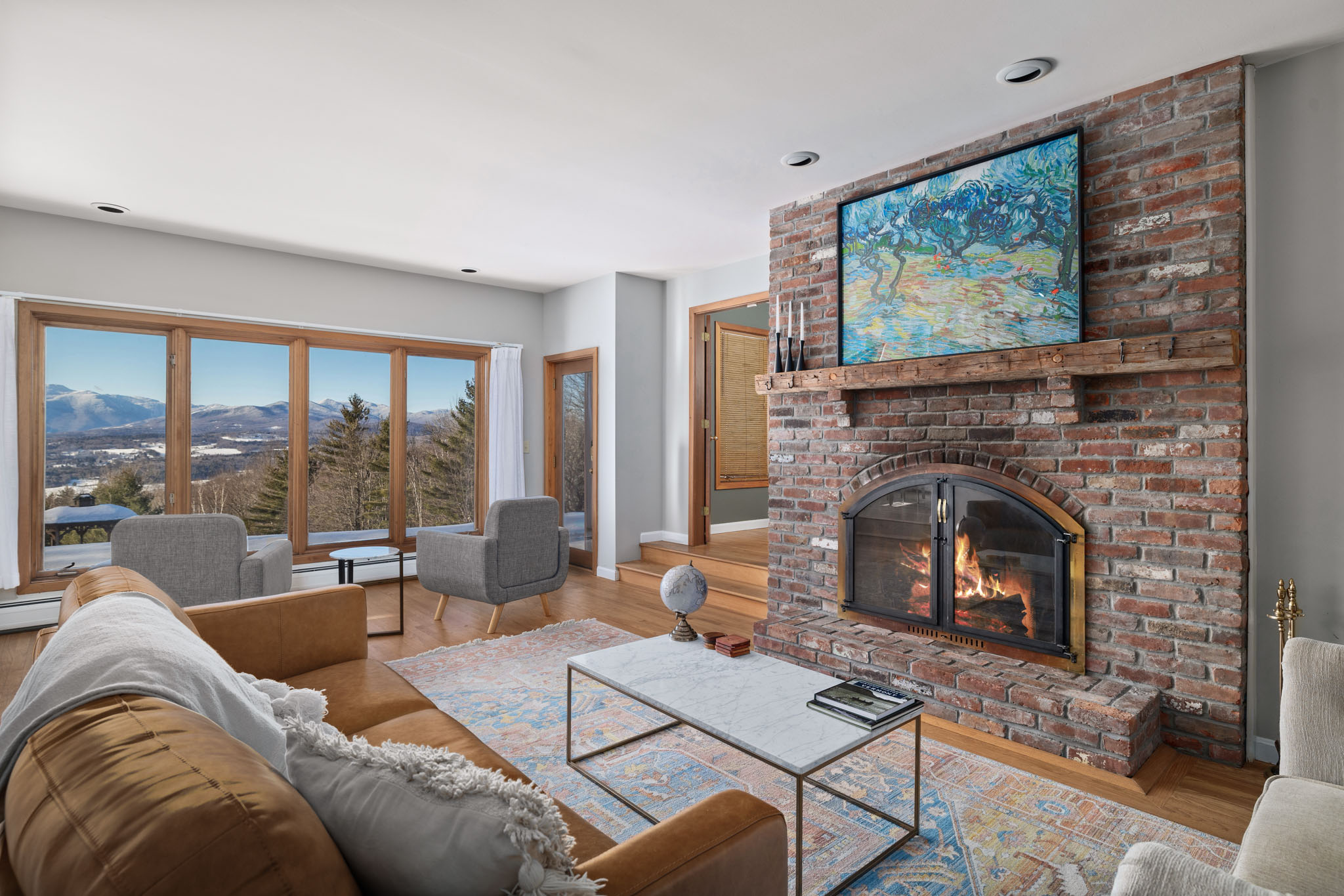 Living room with wood-burning fireplace, comfortable furnishings. Living room with wood-burning fireplace, comfortable furnishings. - Modern Retreat ~ Stunning Mountain View ~ Hot Tub! - Stowe