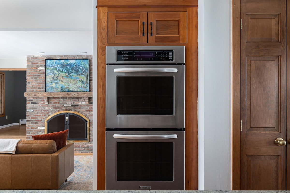 The kitchen features a double oven and connects to the Living Room. The kitchen features a double oven and connects to the Living Room. - Modern Retreat ~ Stunning Mountain View ~ Hot Tub! - Stowe