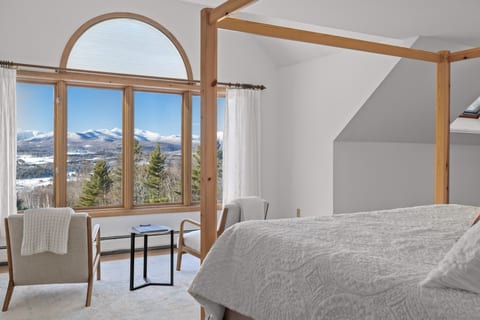 A cozy canopy bed makes way for a grand vaulted ceiling in the master bedroom.