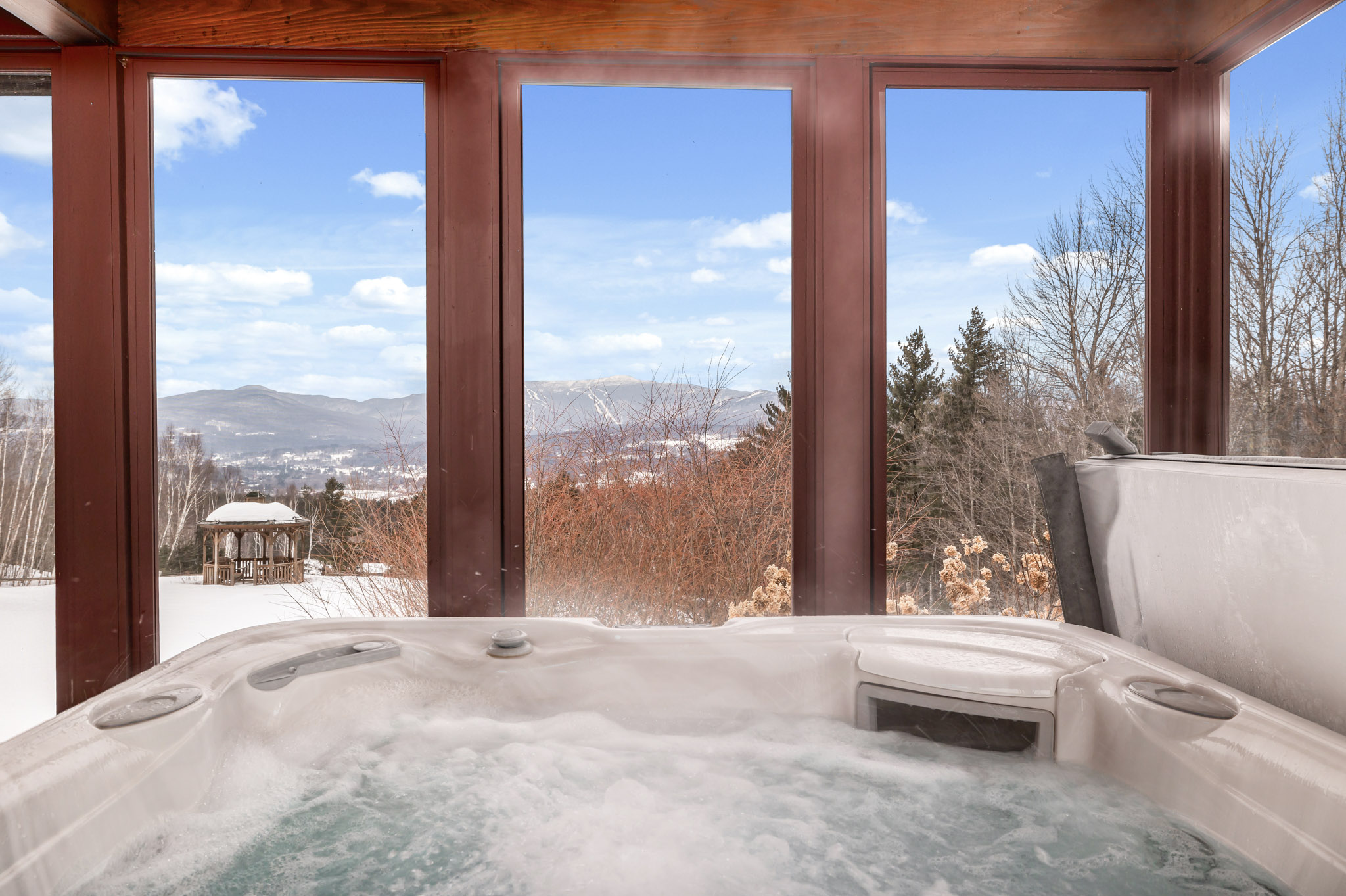 Enjoy the view of Mt. Mansfield from the hot tub. Enjoy the view of Mt. Mansfield from the hot tub. - Modern Retreat ~ Stunning Mountain View ~ Hot Tub! - Stowe