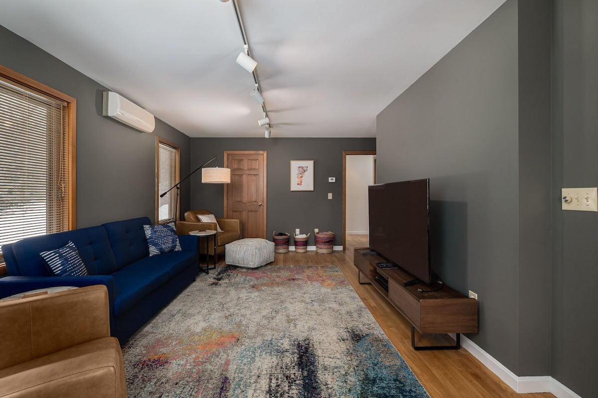 The downstairs TV room is accessible from the foyer and the living room. The downstairs TV room is accessible from the foyer and the living room. - Modern Retreat ~ Stunning Mountain View ~ Hot Tub! - Stowe