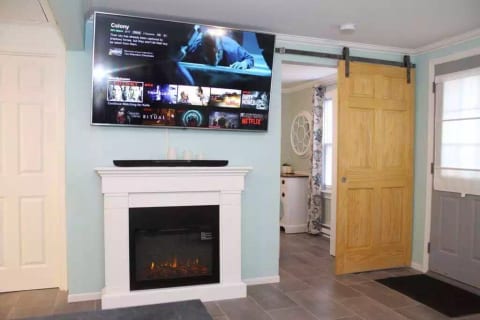 The large TV is great for watching your favorite Netflix movie on. Electric fireplace. The sliding door is to the bedroom.