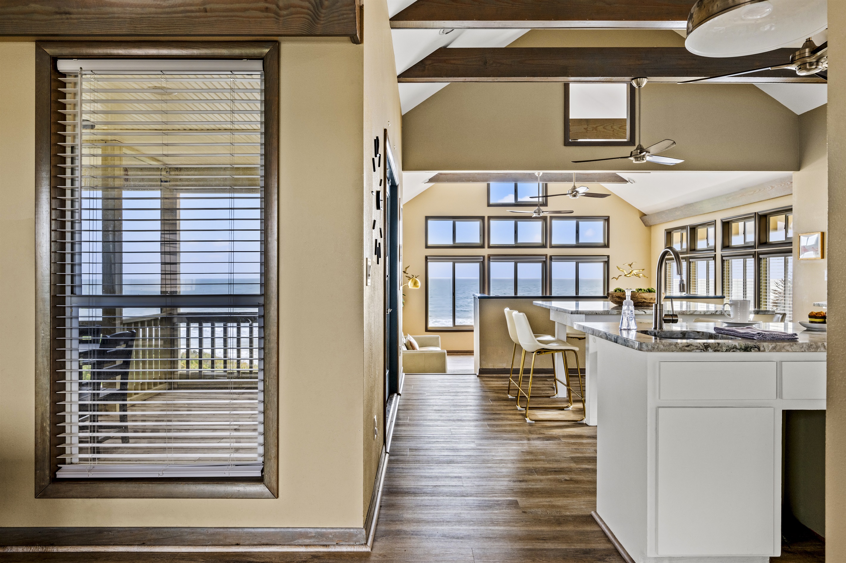 Kitchen area leading to the living room. Kitchen area leading to the living room. - Family Beachfront Oasis - Eastpoint