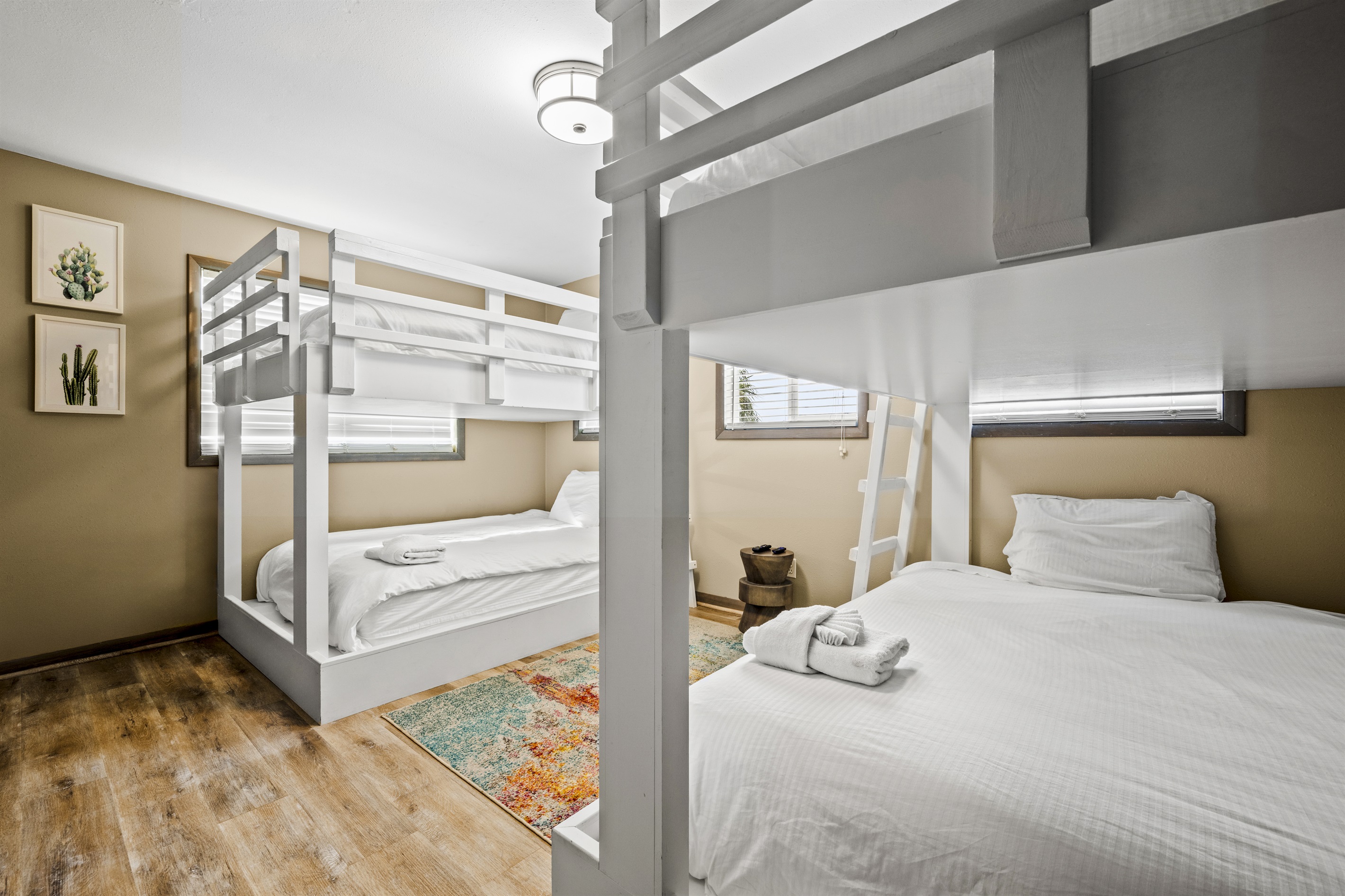 This room features 4 queen beds arranged in 2 bunkbed sets. Perfect for large families, group of friends or guests who want to maximize space while enjoying a good night sleep. This room features 4 queen beds arranged in 2 bunkbed sets. Perfect for large families, group of friends or guests who want to maximize space while enjoying a good night sleep. - Family Beachfront Oasis - Eastpoint