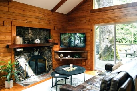 Cozy up on the couch or recliner while enjoying your favorite shows on the 50" smart TV with Netflix available for streaming. The sliding glass door opens to a side deck and yard, and the skylights above let you stay connected to the outdoor beauty.