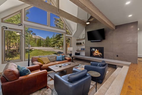 Main living room, patio door to deck, grill and hot tub.