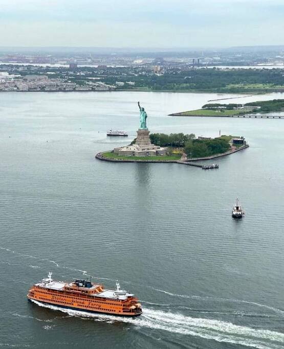 Helicopter view of Staten Island Ferry boat and Statue of Liberty. - NYC Apartment By The Free Ferry In Staten Island! - Richmond County