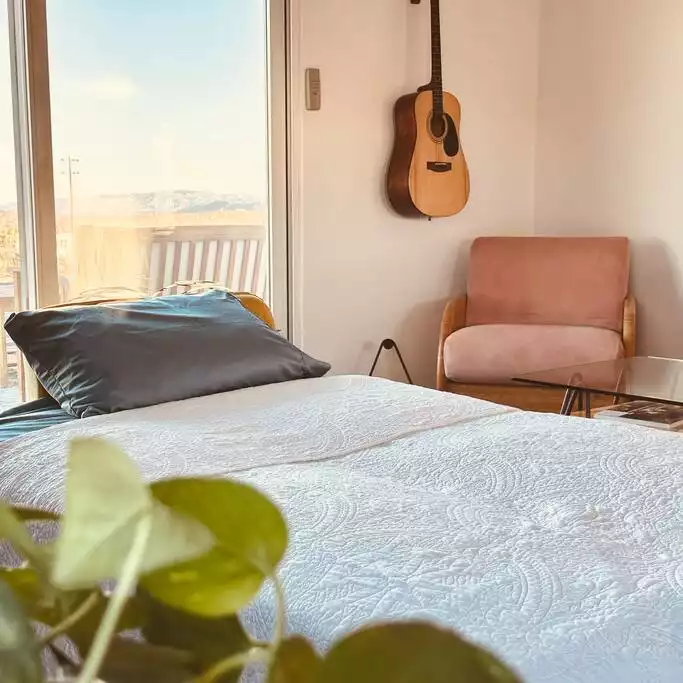 Living room sofa folds down into a single bed. There is a sliding door on the room for privacy. Living room sofa folds down into a single bed. There is a sliding door on the room for privacy. - The Filmmakers House - Joshua Tree