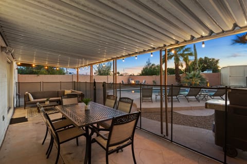 Covered patio with large dining table and a L-shaped sectional. Propane Grill also available! Perfect for relaxing and spending time with friends.