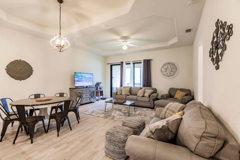 The living room has an open layout, featuring a luxurious sofa and a smart television. It also opens up to the second-floor lanai.
